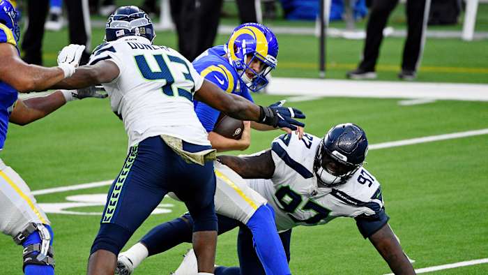 Los Angeles Rams quarterback Jared Goff (16) braces for the sack by Seattle Seahawks defensive end Carlos Dunlap (43) during the second half at SoFi Stadium.